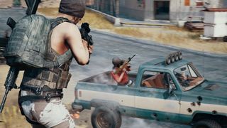 PUBG player aiming at another player who is in the back of a pickup truck