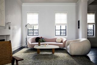 neutral living room with blush pink curved sofa by M.Naeve