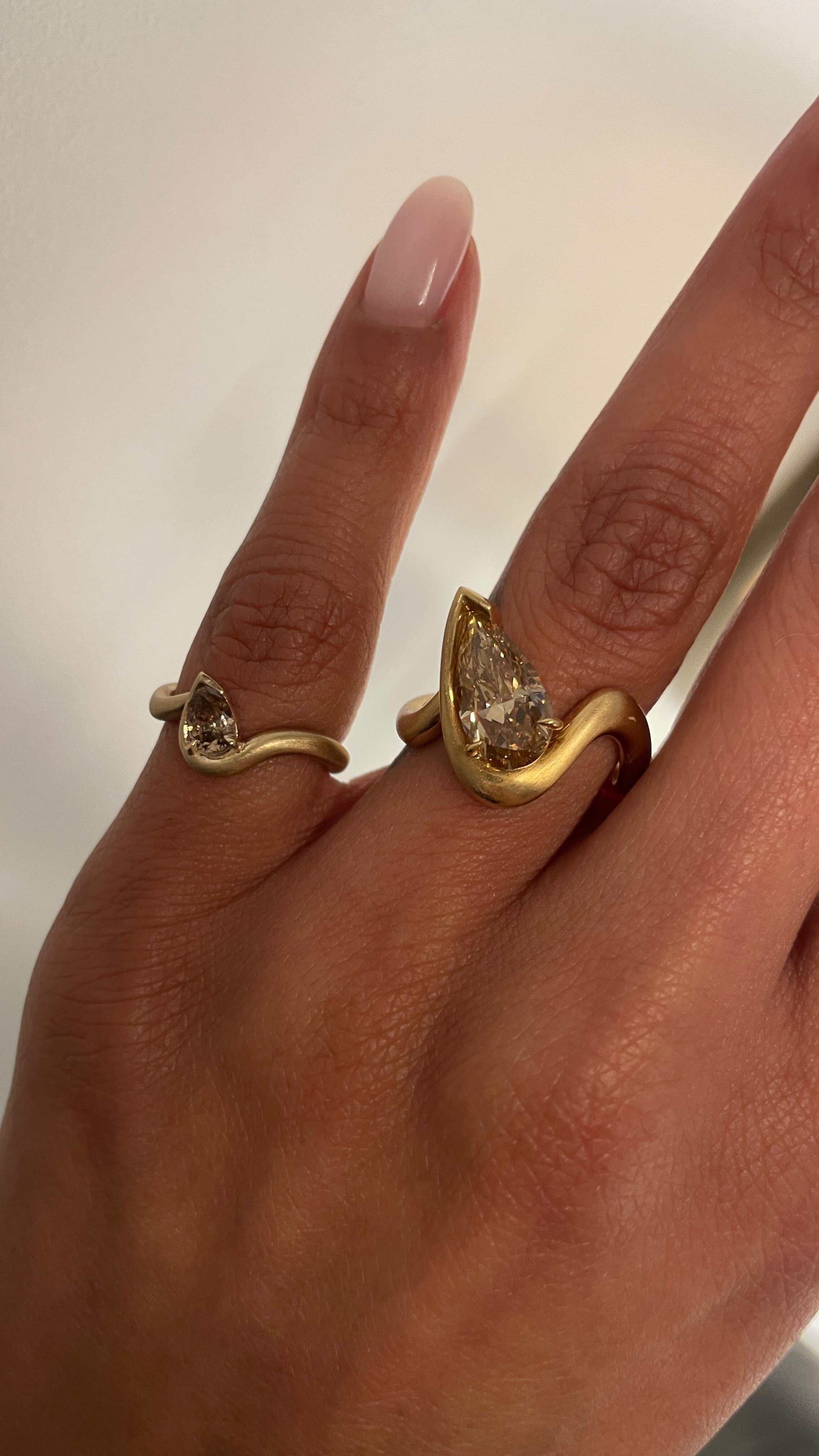 A woman wears the thelma ring and bb thelma pinky ring.