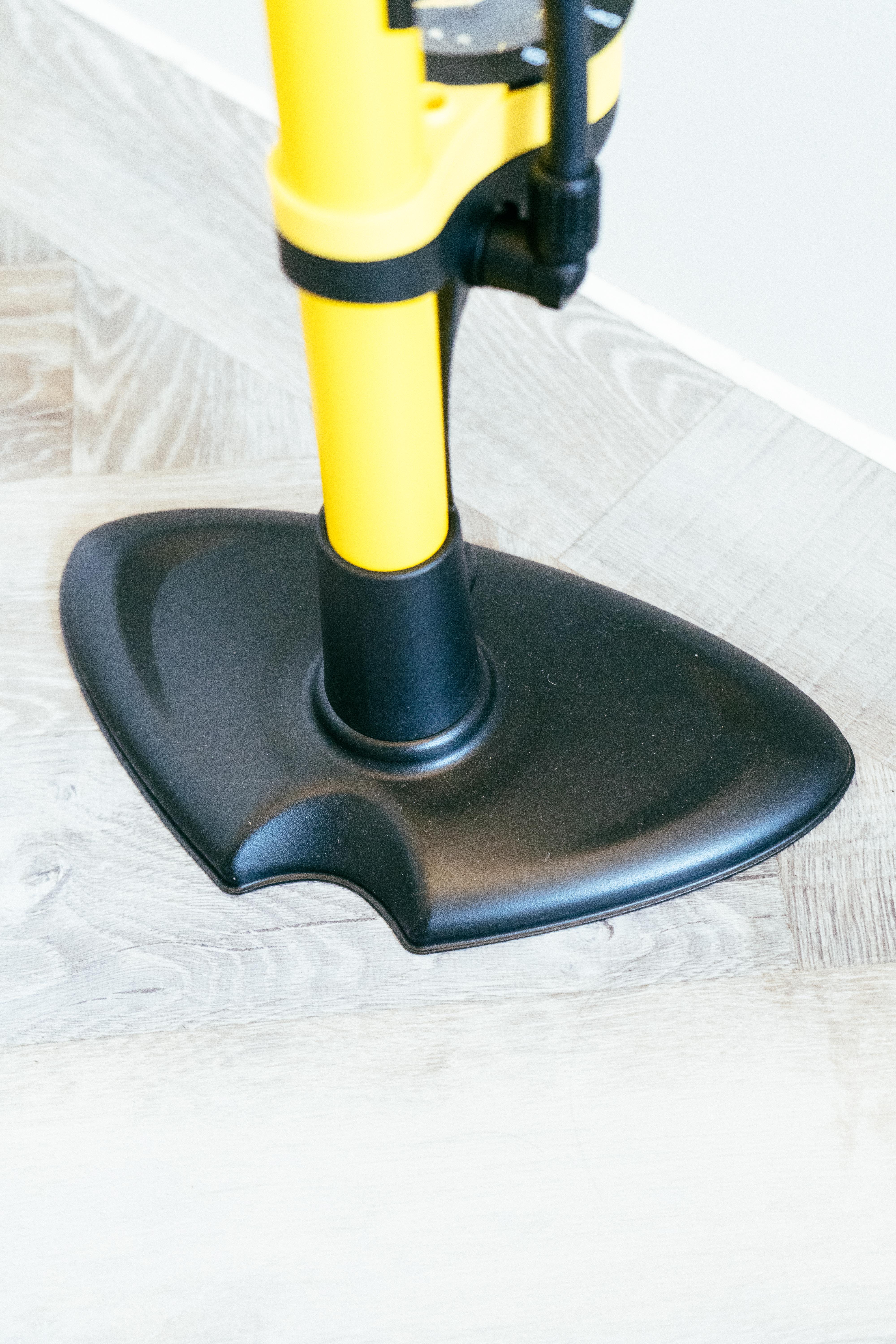 The large base of a yellow floor pump