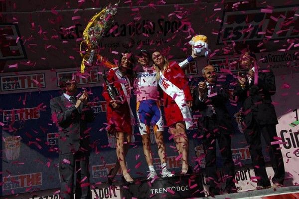 Race leader Denis Menchov is showered with confetti on the podium