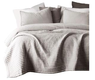 grey comforter set on a bed