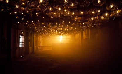 Empty factory with glass hanging from ceiling 