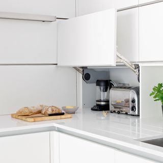 Toaster in appliance garage in white kitchen