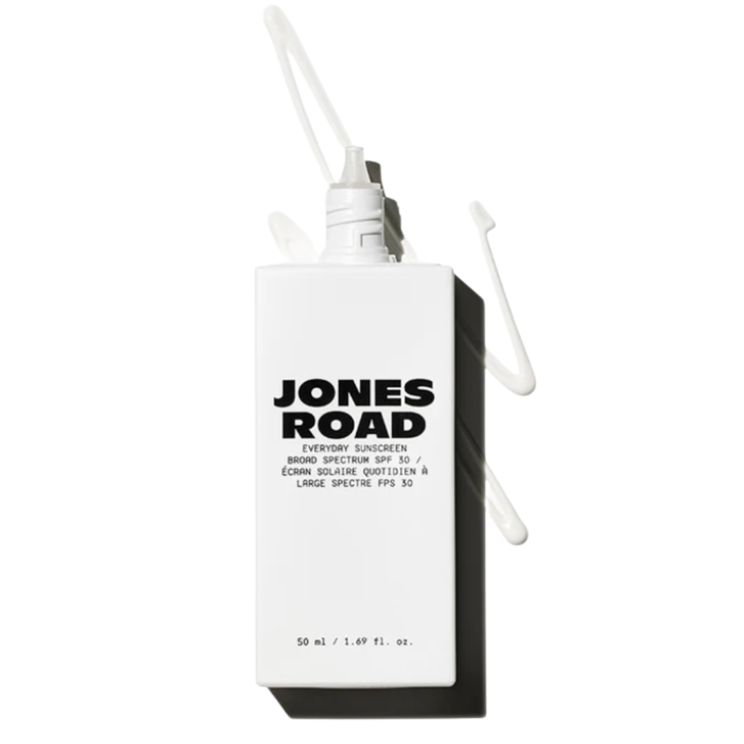 A product shot of the Jones Road Everyday Sunscreen, on white background with a spill of the sunscreen on it