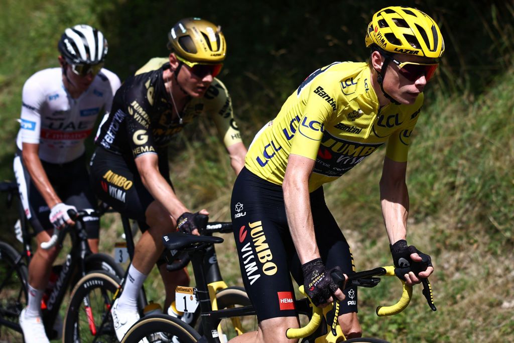 Jumbo-Visma's Danish rider Jonas Vingegaard wearing the overall leader's yellow jersey (R) cycles ahead of Jumbo-Visma's Dutch rider Wilco Kelderman (C) and UAE Team Emirates' Slovenian rider Tadej Pogacar wearing the best young rider's white jersey (L) during the 12th stage of the 110th edition of the Tour de France cycling race, 169 km between Roanne and Belleville-en-Beaujolais, in central-eastern France, on July 13, 2023. (Photo by Anne-Christine POUJOULAT / AFP)