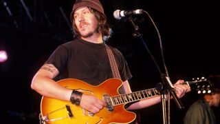 Elliott Smith performs on stage at Leeds Festival, United Kingdom, 1998. He is playing a Gibson ES-330 guitar.