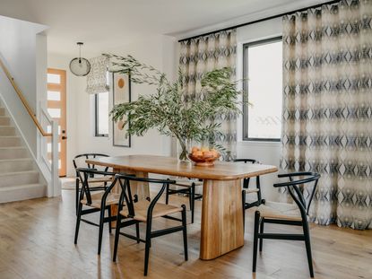 a dining room with monochrome curtains