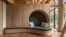 A wooden closet with plush green in-built bench seating