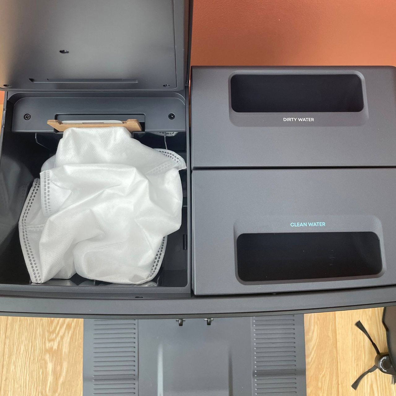 Looking at the top of the Anker eufy Robot Vacuum E35 Omni, showing the dust bag inside the debris chamber