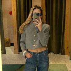 Eliza Huber wearing a gray cropped jacket and Levi's jeans from Aritzia.