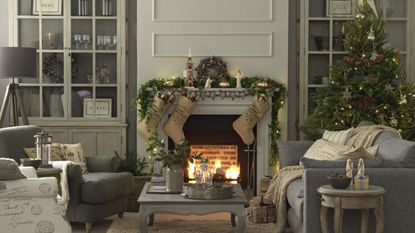 Country style festive living room, Christmas tree, lit open fire.