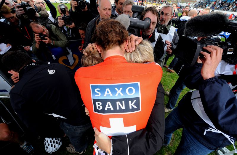 Fabian Cancellara embraces his wife while surrounded by photographers in 2010