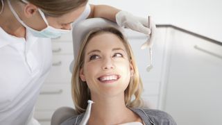 what causes toothache? image shows woman in dentist chair