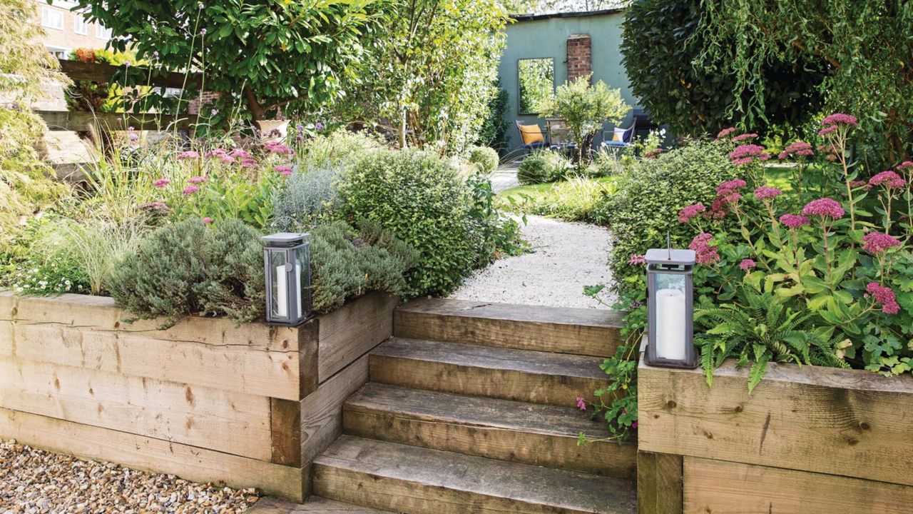 Steps up between the raised beds to the gravel path leading through the garden to the seating area at the end of the garden. 