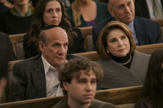 Paul Ben-Victor as Ilan, Tovah Feldshuh as Bina, sitting among congregants in a synagogue, in episode 101 of Nobody Wants This.