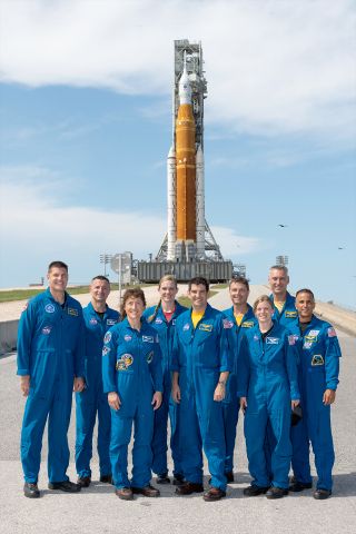 Joe Acaba (at right) poses in front of the Artemis I Space Launch System (SLS) rocket with fellow NASA astronauts, including Reid Wiseman (fourth from right), who he has succeeded as chief of the astronaut office.
