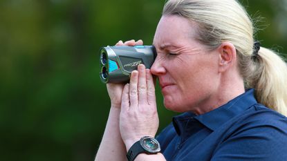 Carly Cummins using a laser rangefinder