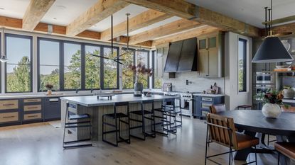 Industrial style kitchen with wooden beams and wooden cabinets with steel countertops