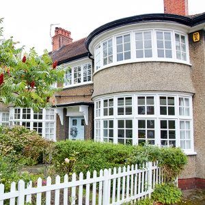 house exterior with white picket fence