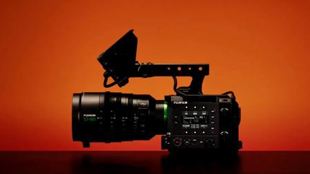 Side profile of the Fufjilm GFX Eterna 55 video camera with a lens and mounted monitor