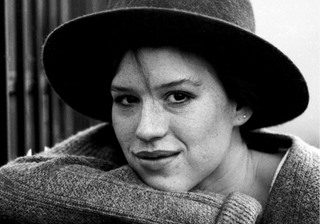 1980s Fashion: Molly Ringwald close up image wearing a hat and knitted sweater