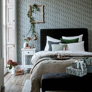Green and white bedroom with foliage and Christmas presents