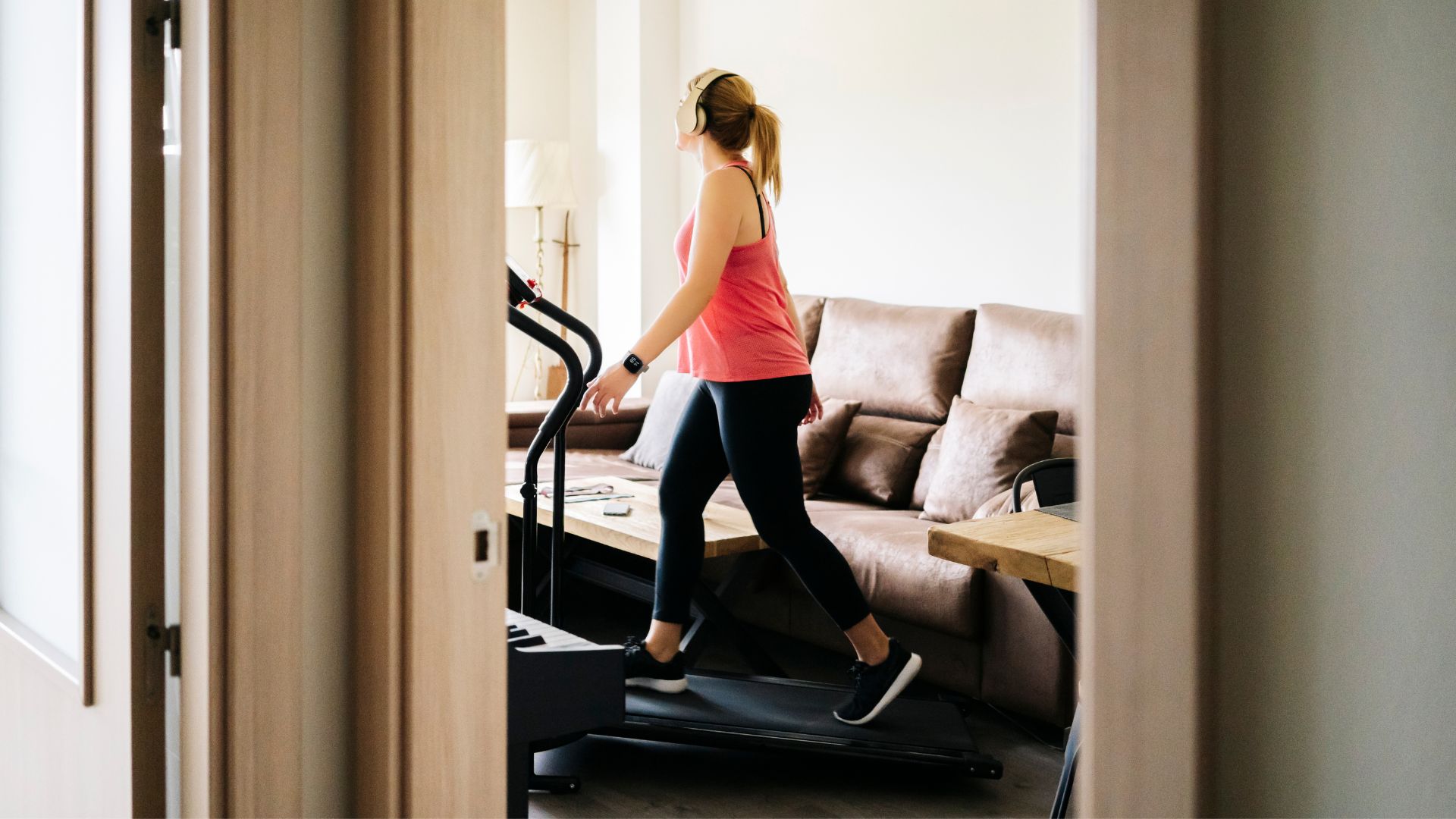 Woman doing the 12-3-30 workout on walking pad at home