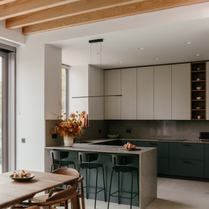 contemporary kitchen dining area with breakfast bar, bar stools, wall units, long dining table