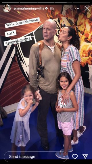 Emma Heming and her daughters next to John McClane wax figure