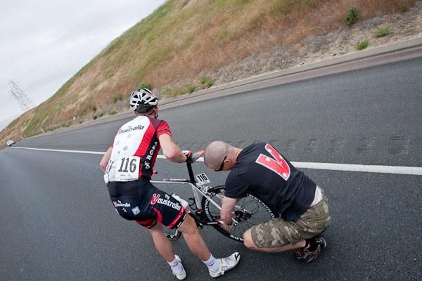 Fly V Australia's Aaron Kemps gets a wheel change from team mechanic Chris Davidson.