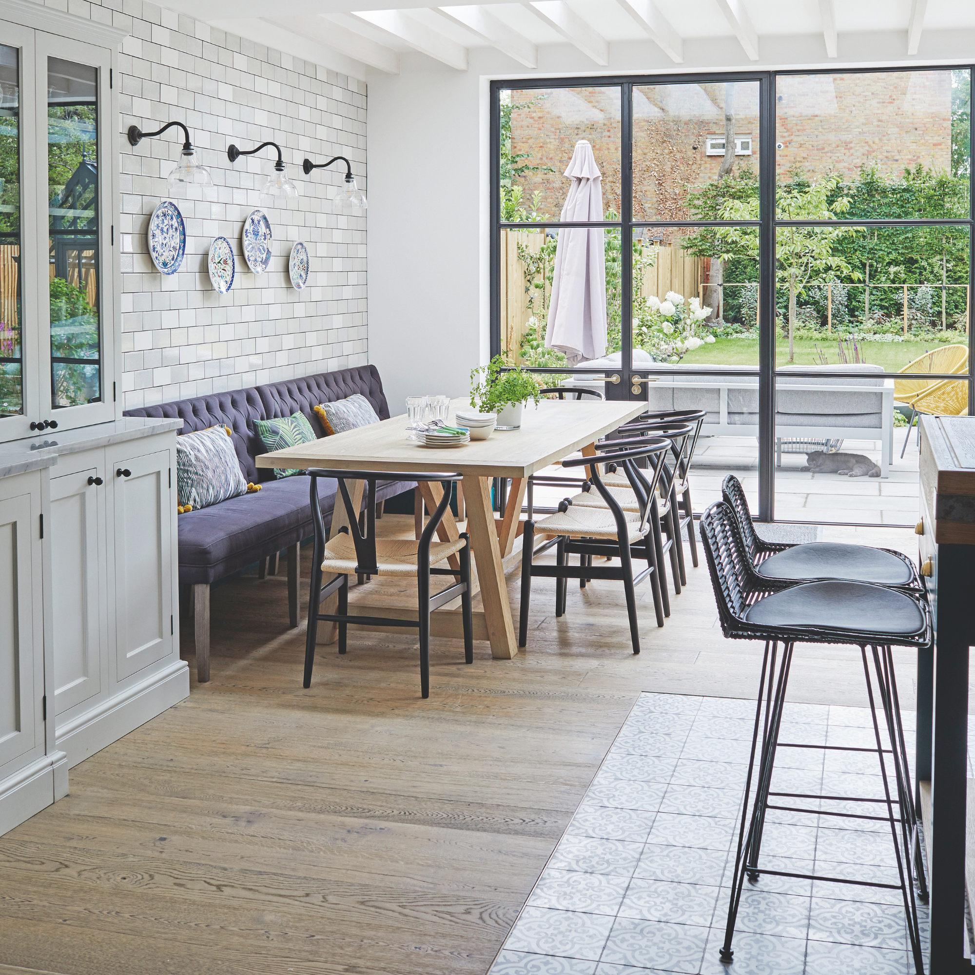 Dining area in large kitchen-diner space, with large crittal doors looking out onto the garden