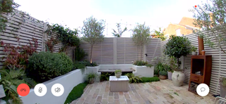 a small courtyard garden seen through a ring doorbell camera