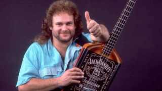 Van Halen’s Michael Anthony posing with a custom Jack Daniel’s bass in 1986