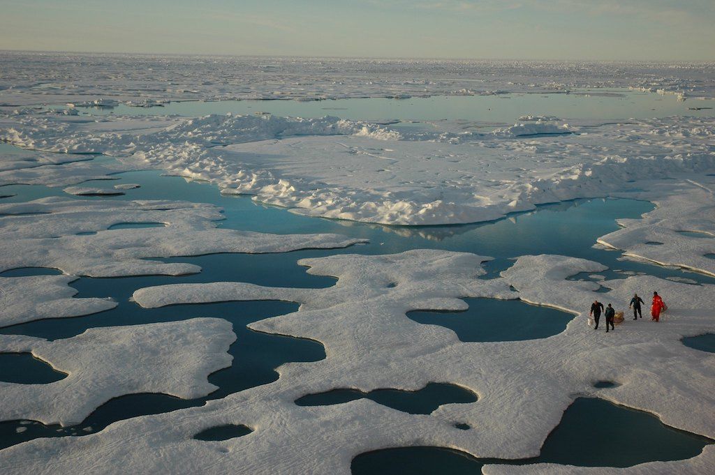 Aerial view of researchers working on Arctic sea ice. 