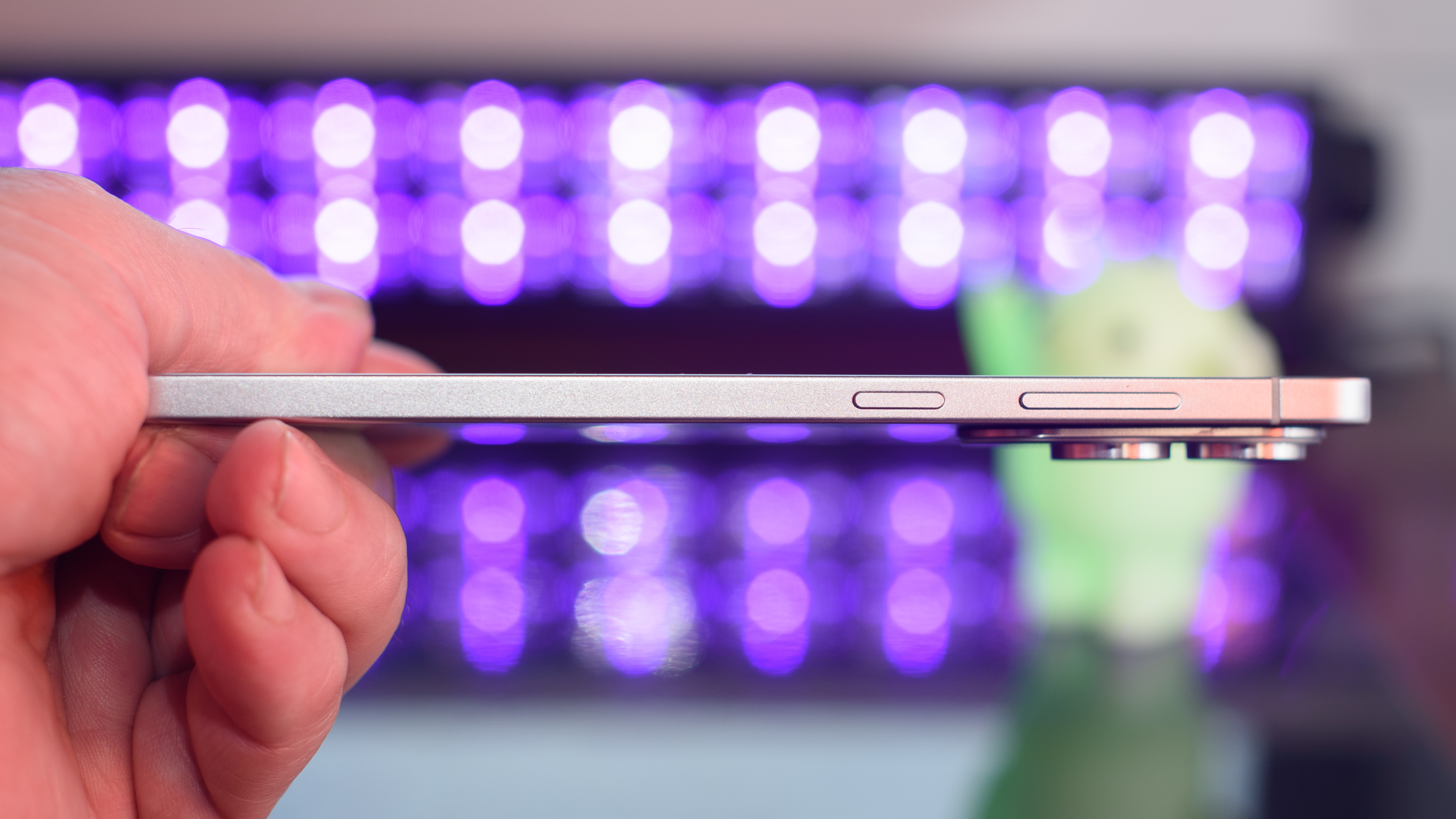 Samsung Galaxy S25 Edge from the other side with black lights blurred in the background