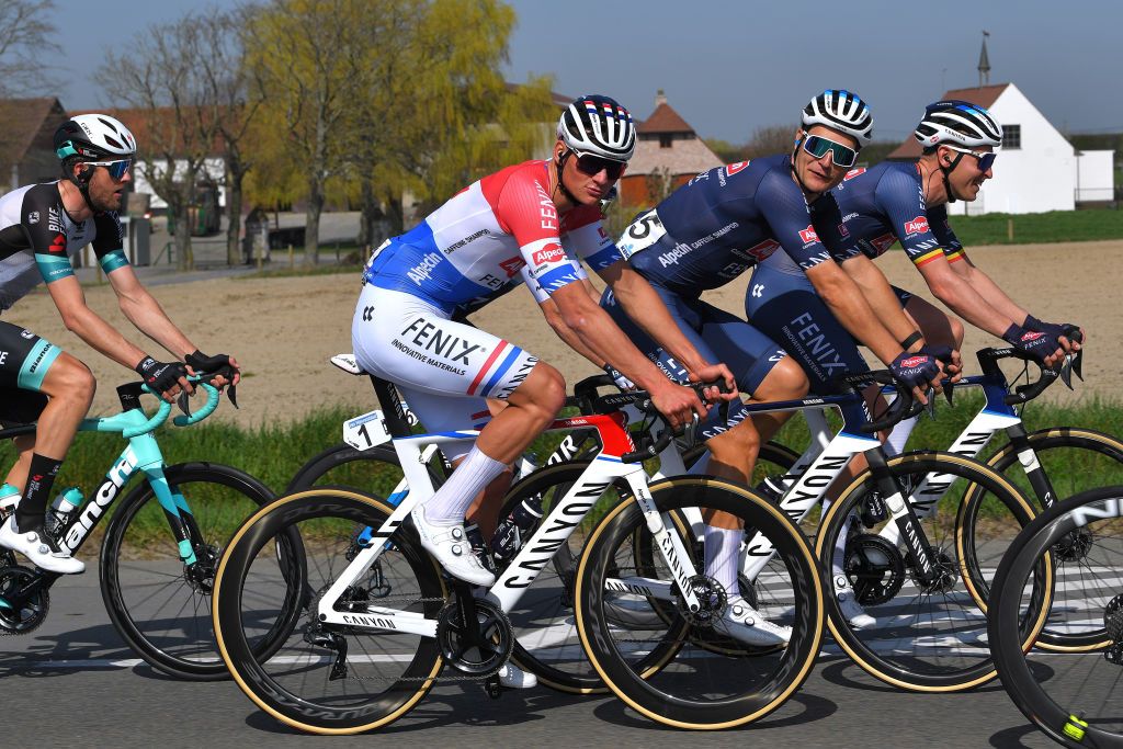 WAREGEM BELGIUM MARCH 31 Mathieu Van Der Poel of Netherlands Jonas Rickaert of Belgium Tim Merlier of Belgium and Team AlpecinFenix during the 75th Dwars Door Vlaanderen 2021 Mens Elite a 1841km race from Roeselare to Waregem DDV DDV21 FlandersClassic A travers la Flandre on March 31 2021 in Waregem Belgium Photo by Luc ClaessenGetty Images