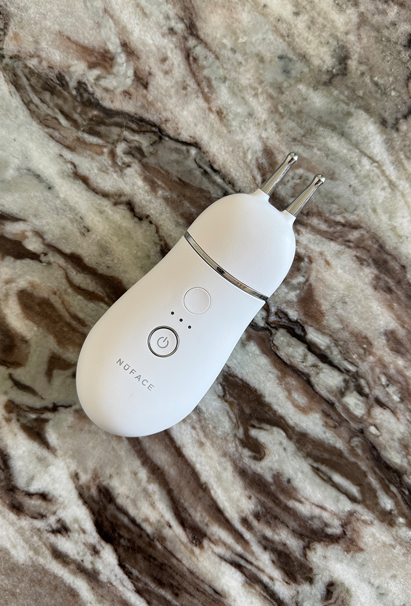 NuFace Trinity lip and eye attachment on a marble table