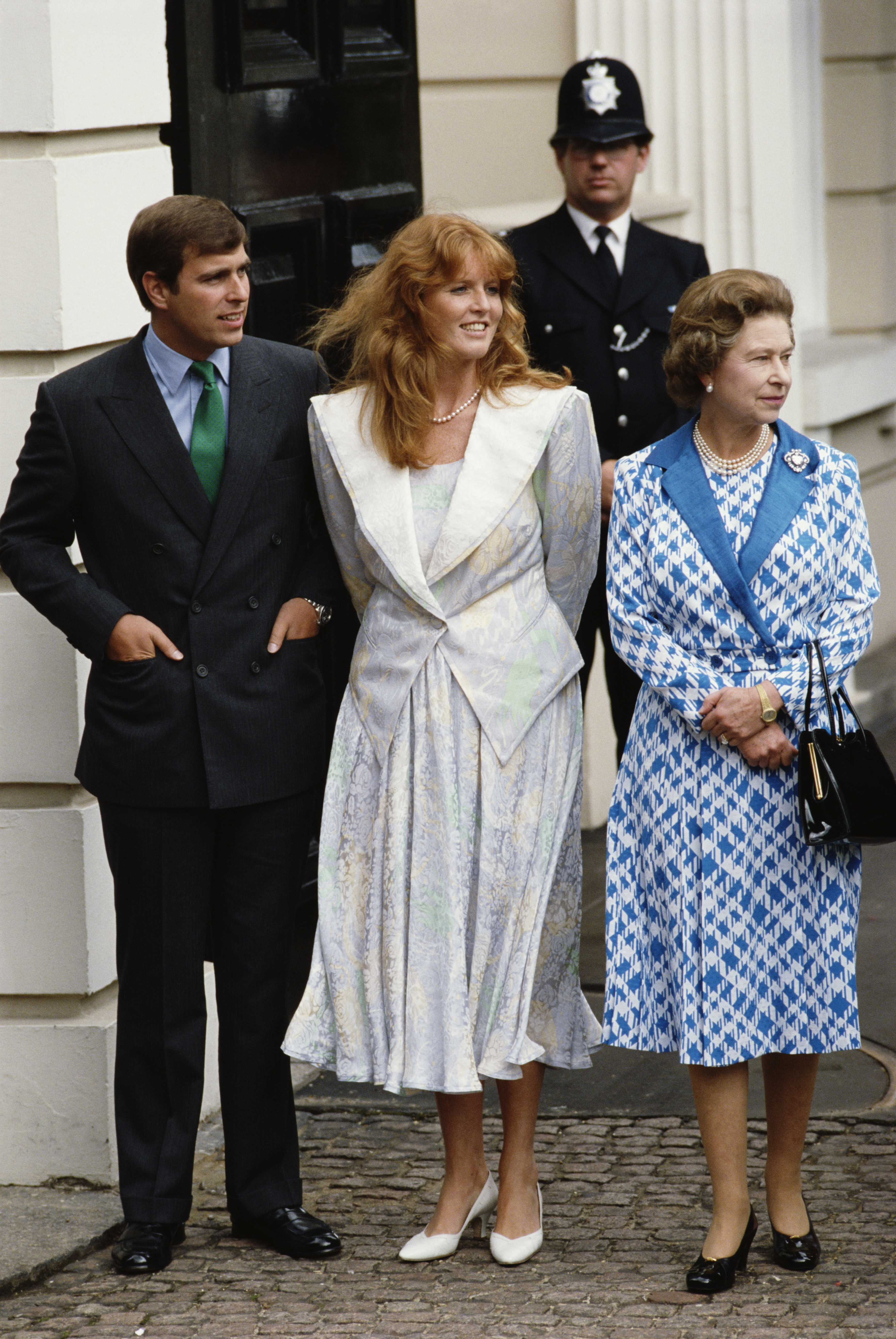 Ex-Prince Andrew, Sarah Ferguson, and Queen Elizabeth II standing outside Clarence House in London for the Queen Mother's 86th birthday on August 4, 1986