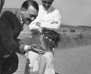 Hitler with a daughter of Reich Minister of Propaganda Joseph Goebbels, 1933 (killed by her parents the day they both committed suicide).