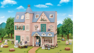 Large Sylvanian Families House set in a garden with blue sky