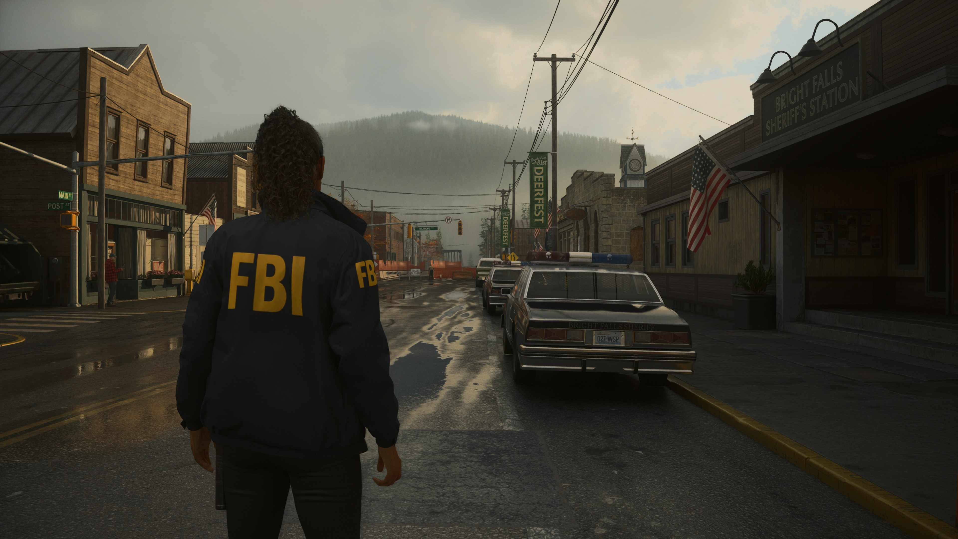 A screenshot from Alan Wake 2 showing the main character walking down a street.