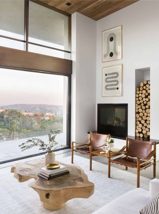 Modern rustic living room designed by Emily Henderson with corner fireplace