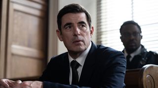 The Dean (Claes Bang) in a suit in court in The Outlaws.