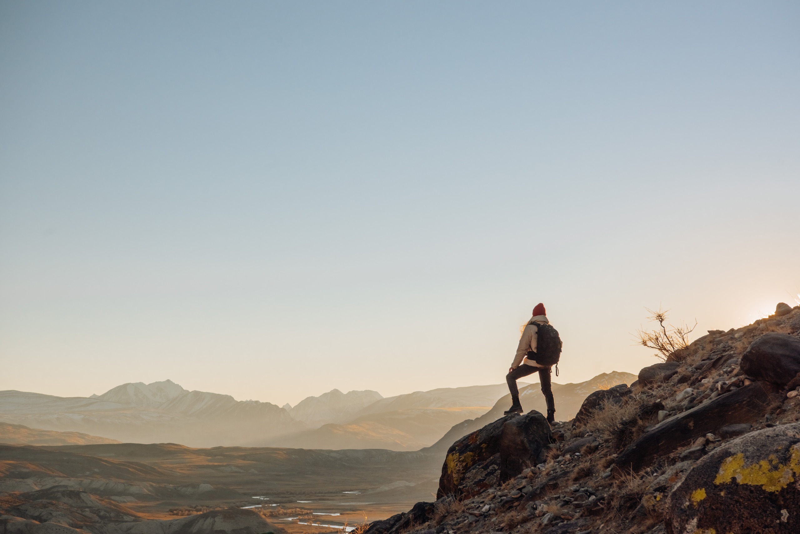 A person hiking and making it to the top.