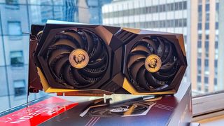 AMD Radeon RX 6600 XT oppå esken sin foran et vindu