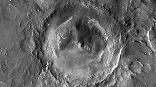 A black and white photo showing a large crater from an aerial view