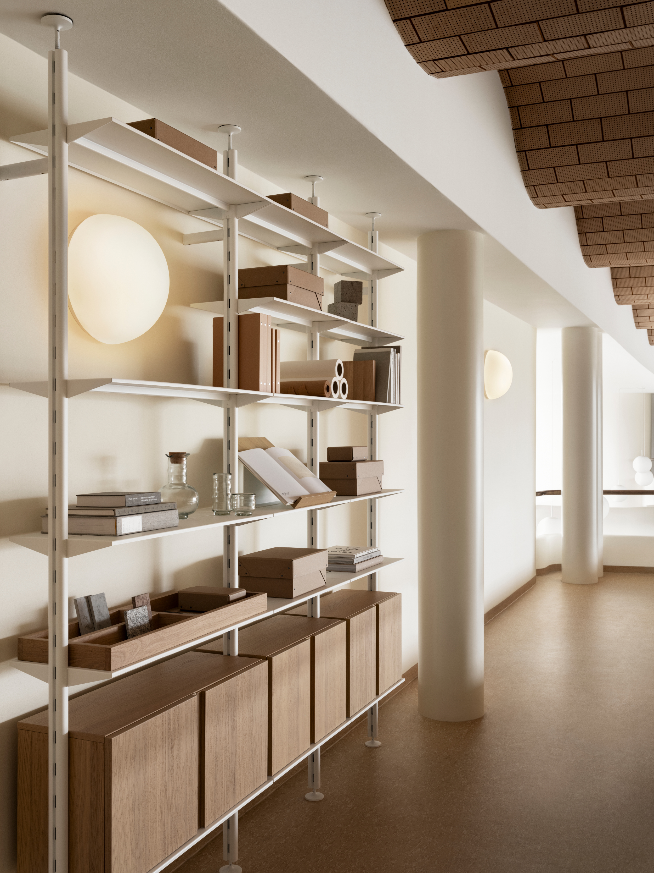 string shelving unit in a modern space with an undulating ceiling