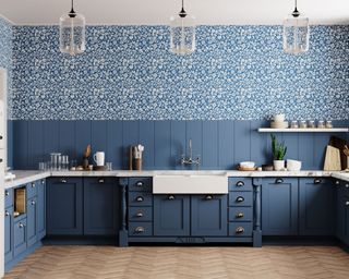 Blue u-shaped kitchen with patterned feature wallpaper