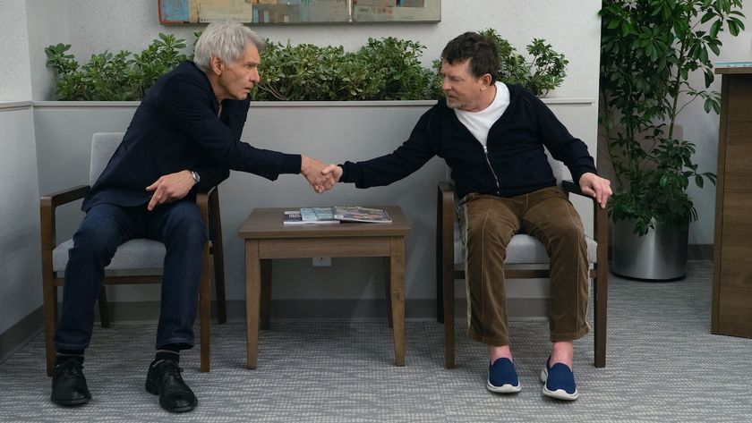 Michael J. Fox shaking hands with Harrison Ford while seated in doctor's waiting room in Shrinking